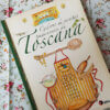 Livro Caderno de Receitas Tradicionais da Toscana sobre um tecido floral